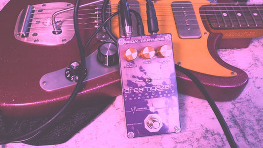 dreamgazer reverb pedal made for shoegaze leaned on a pink guitar