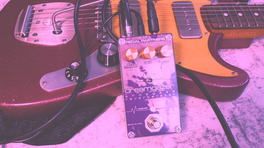 dreamgazer reverb pedal made for shoegaze leaned on a pink guitar