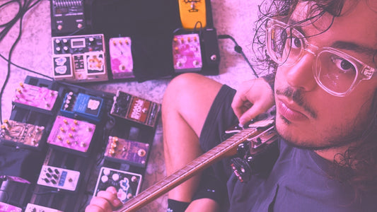 luca of shoegaze band violet oscillation playing guitar surrounded by guitar pedals on effects pedalboards 