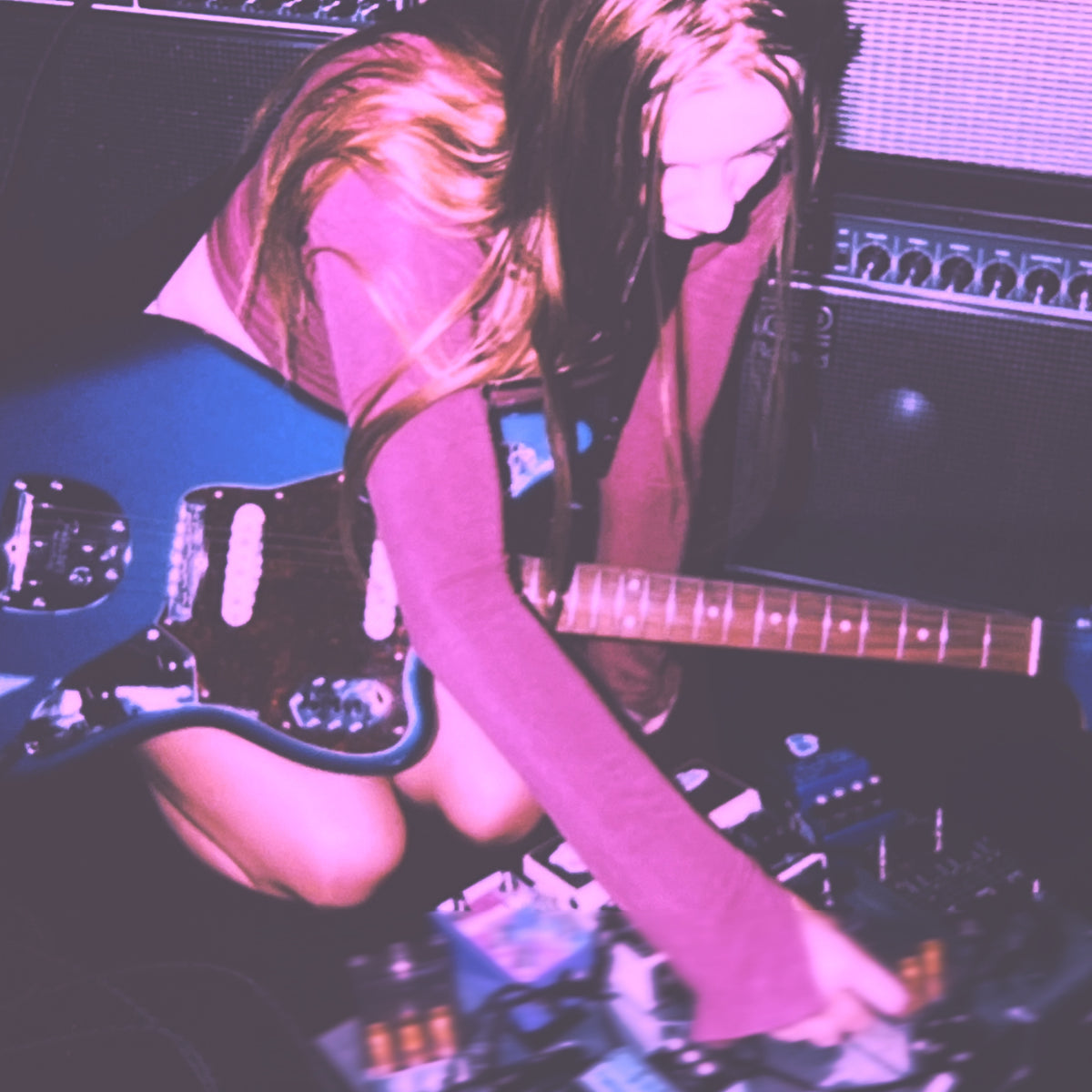 paige of shoegaze band abstract in sound playing guitar with a pedalboard